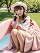 A woman sitting on top of a pink inflatable pool.