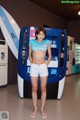 A woman standing in front of a vending machine.