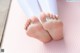 A close up of a person's feet on a pink mat.