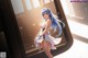 Anime girl with long blue hair wearing a white dress.